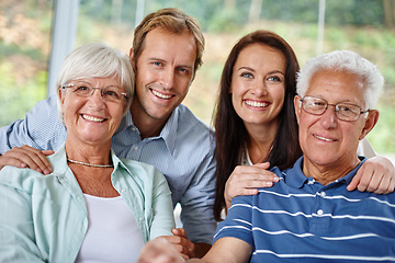 Image showing Family is like a small piece of Heaven. Portrait of a happy family of four smiling at the camera.