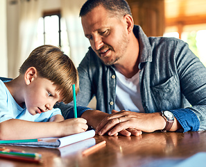 Image showing Dads on standby to help with homework. Shot of a father helping his son with his homework.