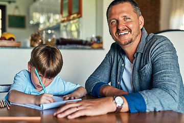 Image showing Hes curious to know about everything from A-Z. Shot of a father helping his son with his homework.