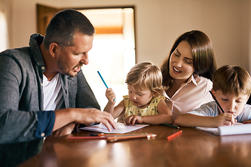 Image showing Engaging their kids in creative play. Shot of a young family of four drawing and getting creative together at home.