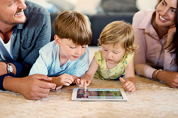 Image showing The learning never ends with technology. Shot of a young family of four using a digital tablet together at home.