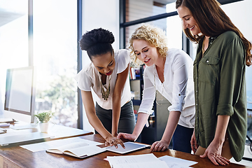 Image showing Making vital decisions together to improve their chances at success. Cropped shot of a team of designers working together in the office.