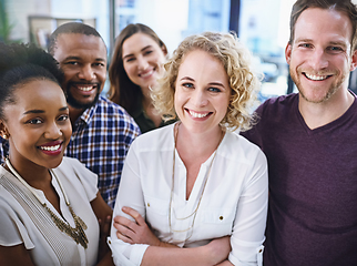 Image showing We work for success rather than just dream about it. Portrait of a team of designers standing together in the office.