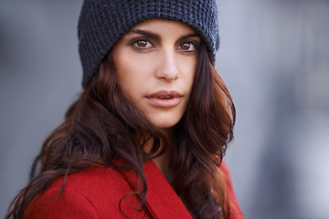 Image showing Ravishing in red. Cropped portrait of a beautiful young woman standing outside.