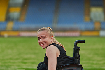 Image showing A woman with disablity driving a wheelchair on a track while preparing for the Paralympic Games