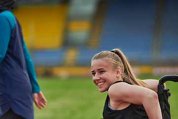 Image showing A woman with disablity driving a wheelchair on a track while preparing for the Paralympic Games