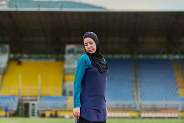 Image showing A Muslim woman with a burqa, an Islamic sportswoman resting after a vigorous training session on the marathon course. A hijab woman is preparing for a marathon competition