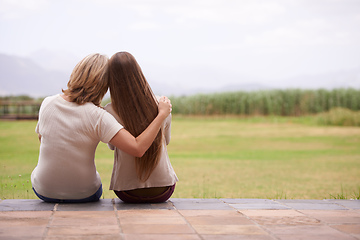 Image showing These moments together are so precious. An affectionate mother sitting outside with her adult daughter.