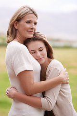 Image showing Everyone needs a hug like that once in a while. A mother embracing her daughter.