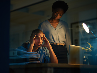 Image showing I never seem to see the end of my deadlines. Cropped shot of a young businessman looking stressed out while a colleague tries to console him.