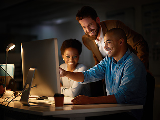 Image showing This looks like our best choice.... Cropped shot of a group of colleagues working late in an office.