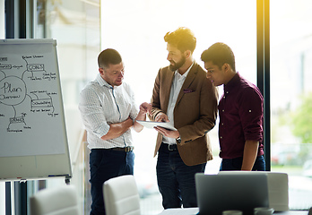 Image showing Sharing the latest updates together. Cropped shot of a group of colleagues having a discussion in an office.