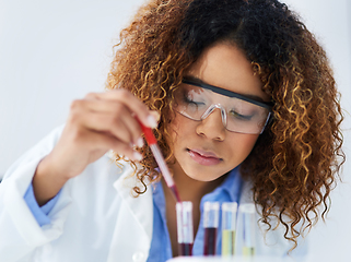 Image showing Testing each one individually. Cropped shot of a young female scientist separating samples in the lab.