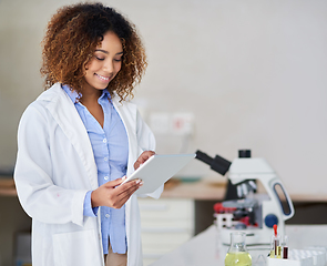 Image showing Recording the results. Cropped shot of an attractive young woman capturing data on her tablet in the lab.