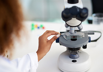 Image showing Time to inspect this sample. Cropped shot of a young female scientist analysing a sample in the lab.