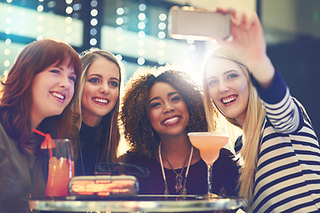 Image showing Get your selfie faces ready. Shot of a group of happy friends taking a selfie while enjoying cocktails.