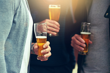 Image showing Good friends, good beer. Cropped shot of a group of unidentifiable friends enjoying a beer together.