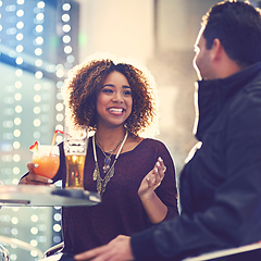 Image showing Drinks are on you, right. Shot of two friends relaxing with cocktails in a nightclub.