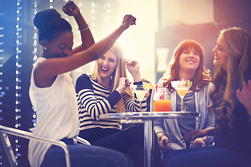 Image showing Thats my jam. Shot of a group of friends relaxing with cocktails in a nightclub.