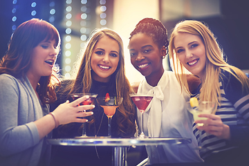 Image showing All you need are good friends and fruity drinks. Portrait of a group of happy friends enjoying cocktails in a nightclub.