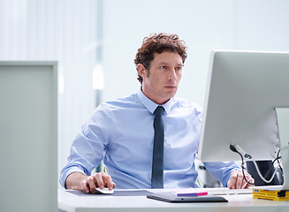 Image showing Focussed on his work. Cropped shot of a young businessman working at his desk.