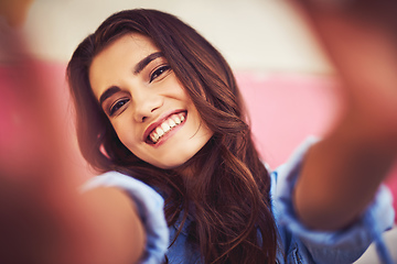 Image showing Being happy is all about how you look at things. Cropped shot of a beautiful young woman taking a selfie against a wall outside.