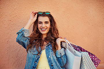 Image showing Laughter and shopping is definitely the best medicine. Cropped shot of a beautiful young woman on a shopping spree in the city.