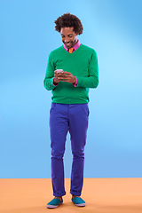 Image showing Status update Looking sweet. Studio shot of stylish young man talking on the phone against a colorful background.