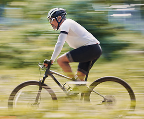 Image showing Fitness, freedom and man cycling in forest for speed, training or nature, workout and off road race. Energy, workout and cyclist on mountain bike for extreme sports, adrenaline or power performance