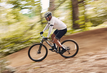 Image showing Blur fast, cycling and man in nature training for a race, marathon or competition in forest. Adventure, fitness and cyclist athlete riding bicycle at speed on mountain for cardio exercise or workout.