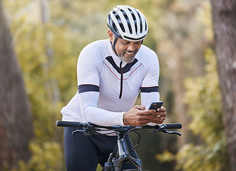 Image showing Nature cycling, phone and happy man, sports athlete or bike rider check digital map, GPS location or direction. Woods, cellphone and cyclist smile for online bicycle info, forest connectivity or app