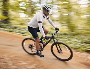 Image showing Blurred speed, cycling and man in nature training for a race, marathon or competition in a forest. Fast, fitness and male cyclist athlete riding bicycle for cardio exercise or workout on a mountain.