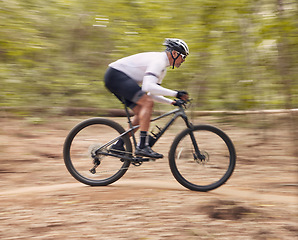 Image showing Fitness, cycling and man with bicycle in a forest for speed, training or workout in nature for off road hobby. Extreme sports, mountain bike and cyclist in woods for workout or adrenaline performance