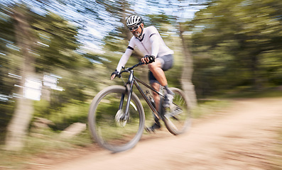 Image showing Nature blur, mountain bike and sports man cycling, action and ride bicycle for cardio, fitness or outdoor exercise. Low angle, fast motion and extreme cyclist training, speed and danger risk in woods