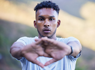 Image showing Portrait, fitness and stretching with a sports man getting ready for a cardio or endurance running workout. Face, exercise and warm up with a serious young runner or athlete outdoor for training