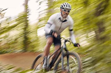 Image showing Blurred nature, cycling and man athlete training for a race, marathon or competition in a forest. Fast, fitness and male cyclist riding bicycle at speed for cardio exercise or workout on a mountain.