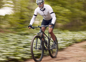 Image showing Fast, fitness and man on a bike in nature for a race, sports or fitness. Energy, mountains and a male cyclist on a bicycle in the woods with speed for exercise, cardio or training in a forest