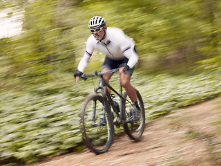 Image showing Fast, cycling and man on a bike in nature for fitness, sports or a competition. Energy, mountains and a male cyclist on a bicycle in the woods with speed for exercise, cardio or training in a forest