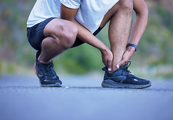 Image showing Fitness, exercise and a man with ankle injury outdoor on run, workout or training. Closeup of athlete person or runner with running shoes and leg pain, hurt muscle or accident on a road for cardio