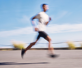 Image showing Exercise, running and motion blur with a sports man on a road for his cardio or endurance workout. Fitness, health and a runner training for a marathon or challenge in the mountains during summer