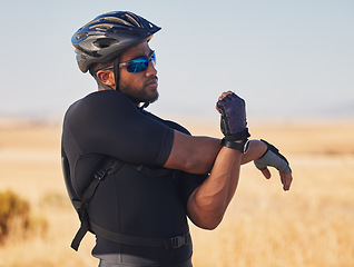 Image showing Fitness, nature and man cyclist stretching arms for race, marathon or competition training. Sports, cycling and male athlete doing warm up exercise for health at an outdoor cardio workout by mountain