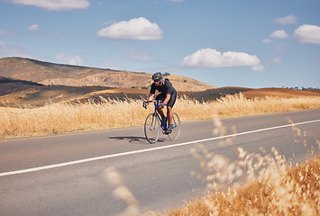 Image showing Fitness, nature and man cycling on road for workout, exercise and scenic mountain path. Health, wellness and cyclist on bike on summer morning for training, practice and bicycle race with blue sky.