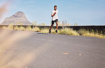 Image showing Man, running and training on road in mountain, nature or outdoor exercise and athlete in healthy workout in Cape Town. Male, runner and morning cardio, sports goals or fitness challenge in summer