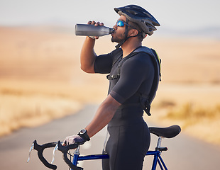 Image showing Fitness, nature and man cyclist drinking water at race, marathon or competition training. Sports, workout and thirsty male athlete with hydration for health at an outdoor cardio exercise with bicycle