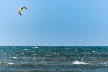 Image showing Kitesurfer riding ocean waves