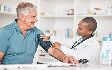 Image showing Pharmacist, senior man and blood pressure check with helping hand, test and happy for healthcare in shop. Black woman, elderly patient and medical support with exam, inspection and wellness in store