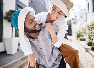 Image showing Happy interracial couple, love or piggyback in city to travel on romantic date to play a fun outdoor game. Smile, eye contact or black man carrying gen z girl in silly, goofy or playful joke together