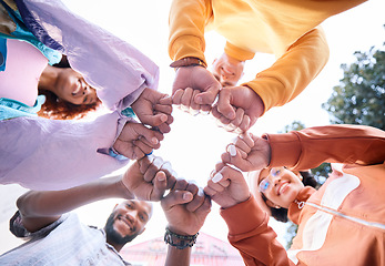 Image showing Friends, hands and people fist bump outdoor for trust, community and fun circle. Diversity, happiness and below gen z group of men and women with solidarity for teamwork, youth and freedom in nature