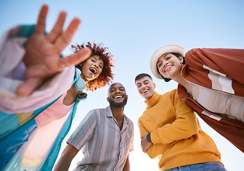 Image showing Portrait, smile and a group of friends on a blue sky outdoor together for freedom, bonding or fun from below. Diversity, travel or summer with happy men and women laughing outside on vacation