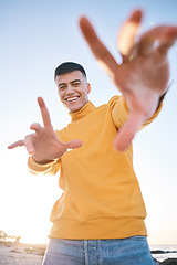 Image showing Frame, portrait and a man with hands at the beach with happiness, freedom and creativity. Smile, holiday and a young person at the sea with a gesture for perspective on vacation at the ocean